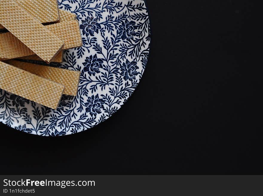 decorated plate with cookies on black abckground