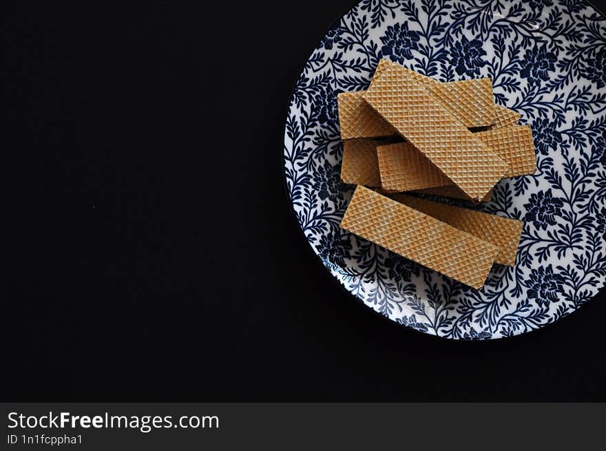 cookies on a plate on black background