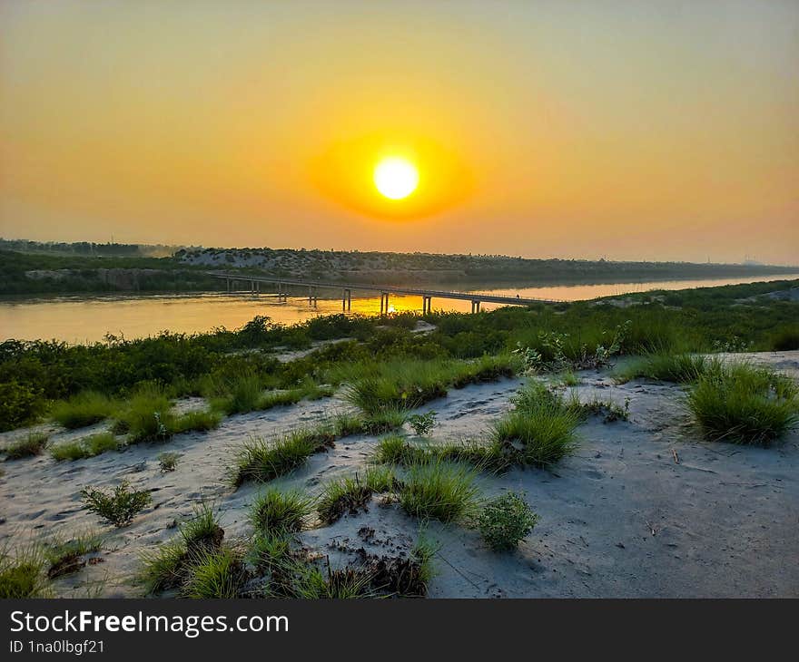 A golden sunset landscape over canal