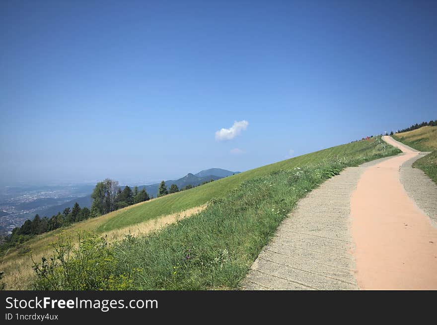 Concrete path on a sunny day in the mountain in summer. Concrete path on a sunny day in the mountain in summer