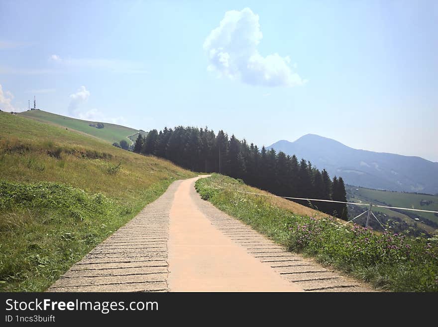 Concrete path on a sunny day in the mountain in summer. Concrete path on a sunny day in the mountain in summer