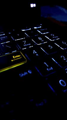 The Keys On A Modern Laptop Keyboard Have A Background Backlight Stock Photo