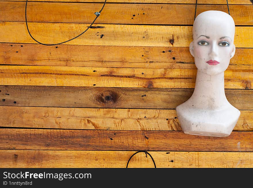 The head of a female mannequin is hanging on the wall