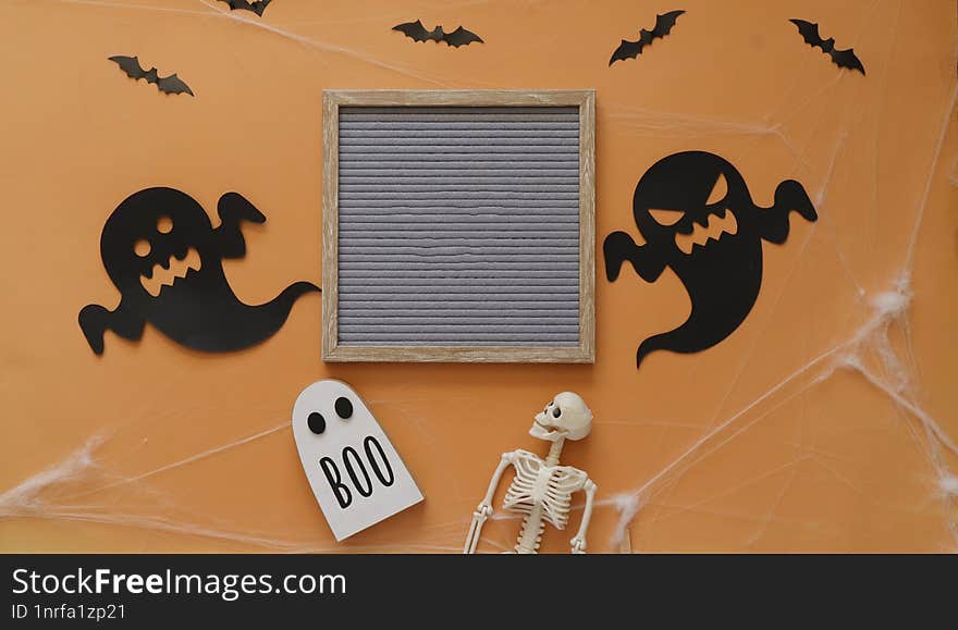 Happy Halloween Holiday Concept With Skeleton , Ghosts, Bats  On Orange Background, Flat Lay, Top View,  Sign Copy Space.