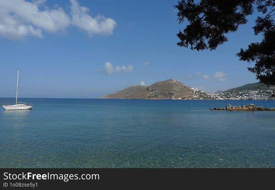 Greek island of Leros, aegean sea and a white sailboat