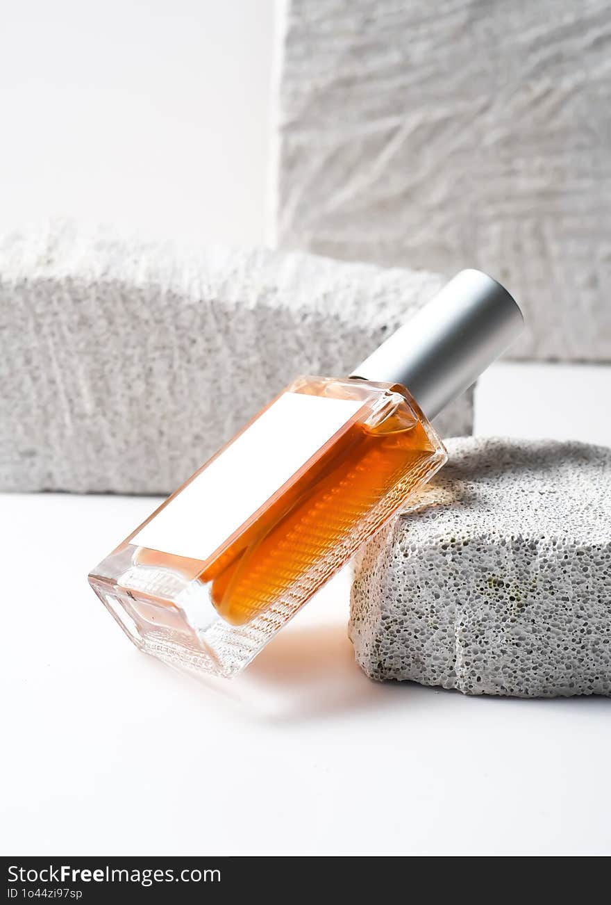 A Perfume Bottle Mockup With A Clean White Label, Set Against A White Stone Background In A Minimalist And Modern Photography Styl