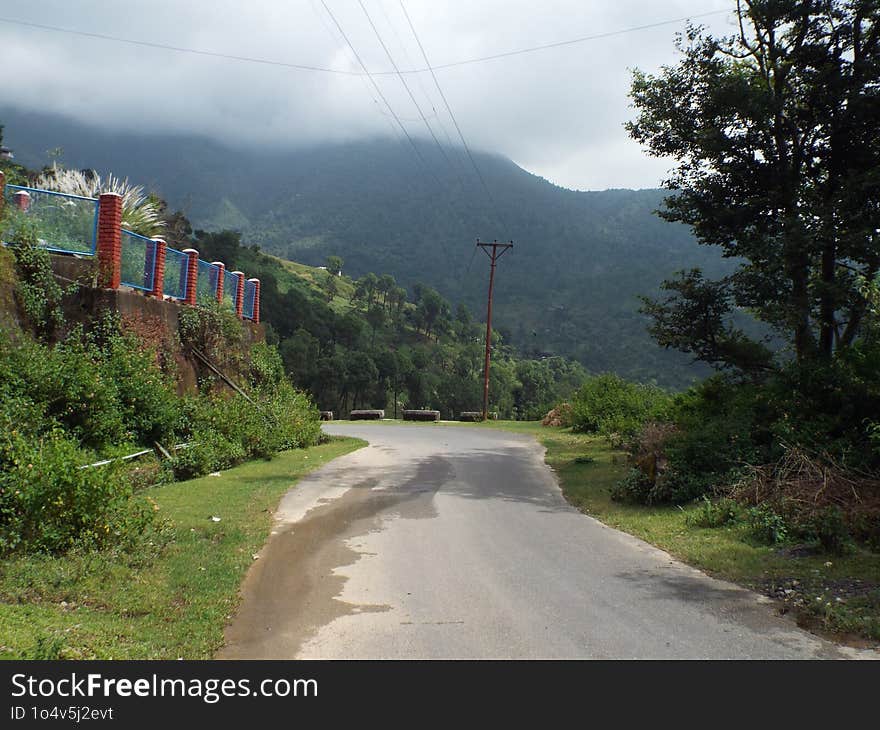 The road leading to some unknown place, far beyond the veil of mist in Kangra Valley, India. The road leading to some unknown place, far beyond the veil of mist in Kangra Valley, India.