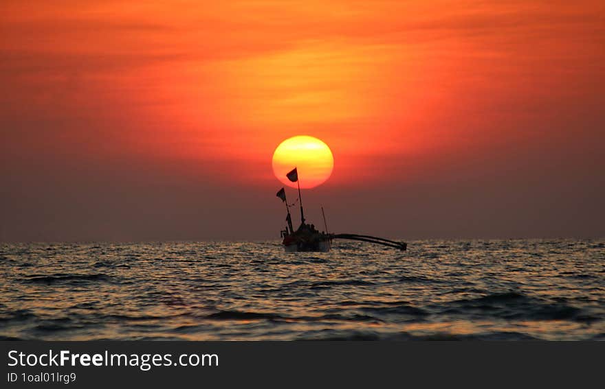 Golden Light Sunset, Sunrise On A Beach With Boat In Foreground