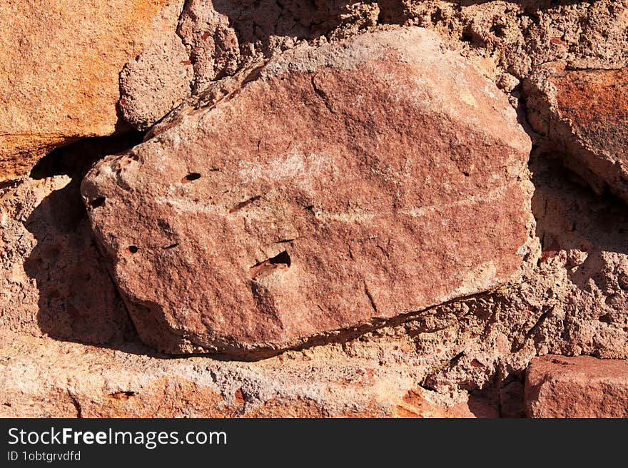 Image of a brown stone wall, masonry.