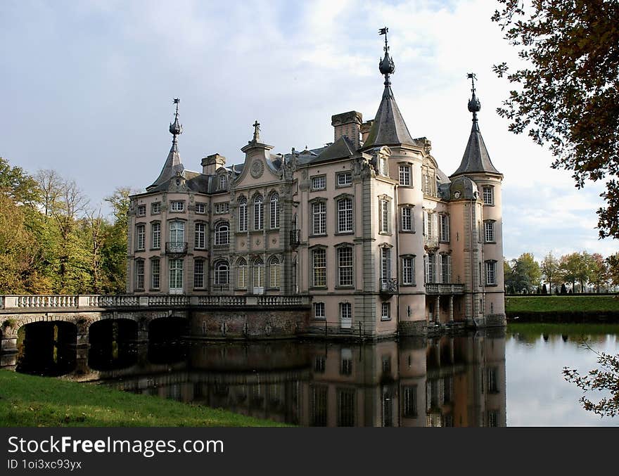 Wonderful historic castle painted in rose colours !!! With trees and water around in beautiful wood !!! With stunning evening light !!!. Wonderful historic castle painted in rose colours !!! With trees and water around in beautiful wood !!! With stunning evening light !!!