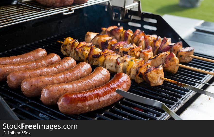 Sizzling Sausages and Juicy Chicken Kebabs Cooking on the BBQ Grill ok