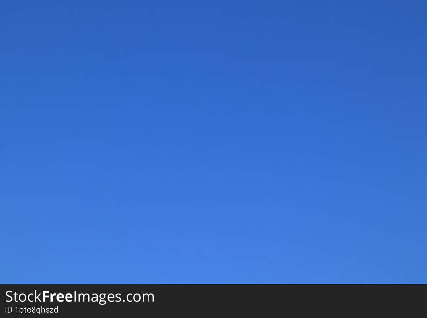 Clear blue peaceful sky early summer morning. Blue background