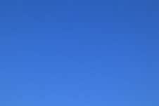 Clear Blue Peaceful Sky Early Summer Morning. Blue Background Royalty Free Stock Photo