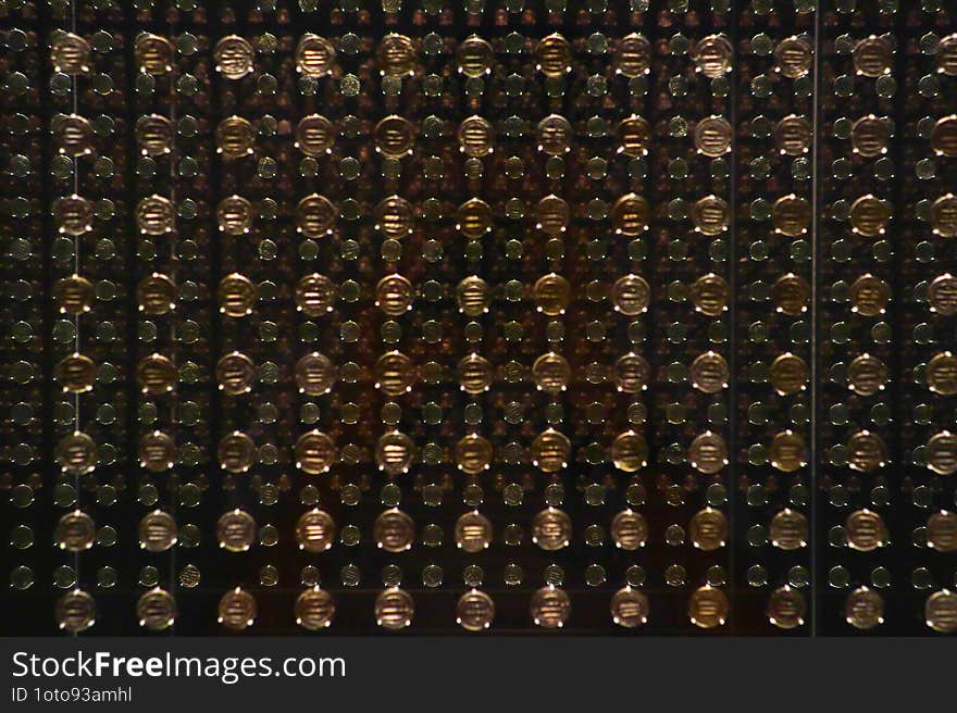 Grid of spherical objects that magnify the black background behind them, creating a repetitive pattern effect