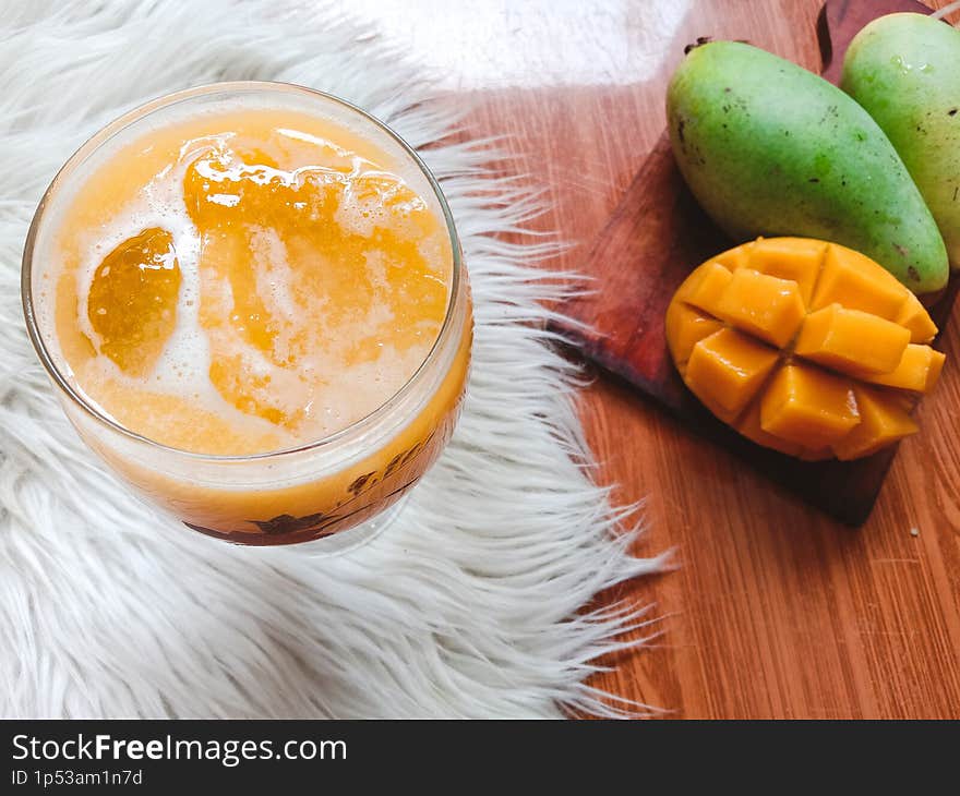 Fresh and sweet mango juice served in a fancy glass.