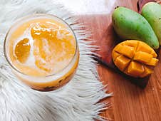 Fresh And Sweet Mango Juice Served In A Fancy Glass. Royalty Free Stock Photography