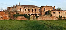 Cascina Torriana, Cernusco Sul Naviglio - March 2023: Ruins Of The Old Abandoned Farmhouse, A Green Meadow In The Foreground. Royalty Free Stock Photos