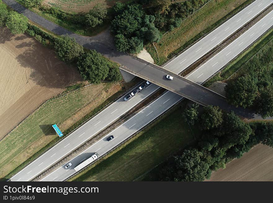 Two lane highway with cars visible, top down aerial view