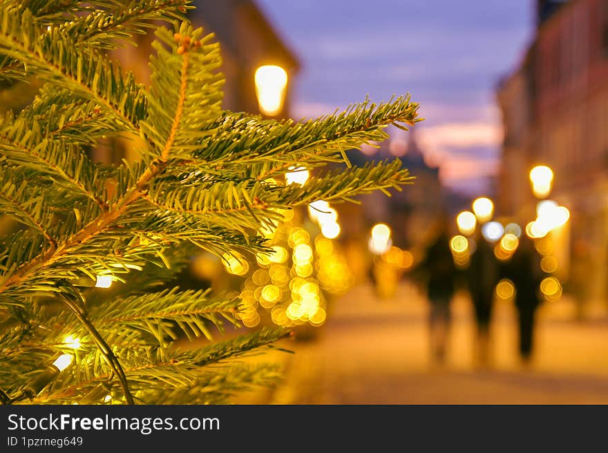 Intentional blur tourist pedestrians walk in Europe street on Xmas surrounded by traditional architecture. Family Christmas holida