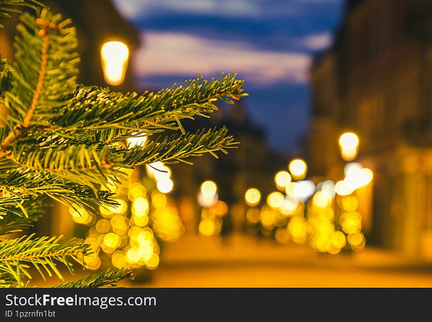 Blurred zoom out background city street with Christmas illuminations, blurred holiday background. Christmas lights and Christmas decorations on the street. Banner, designs. copy space.Xmas new year