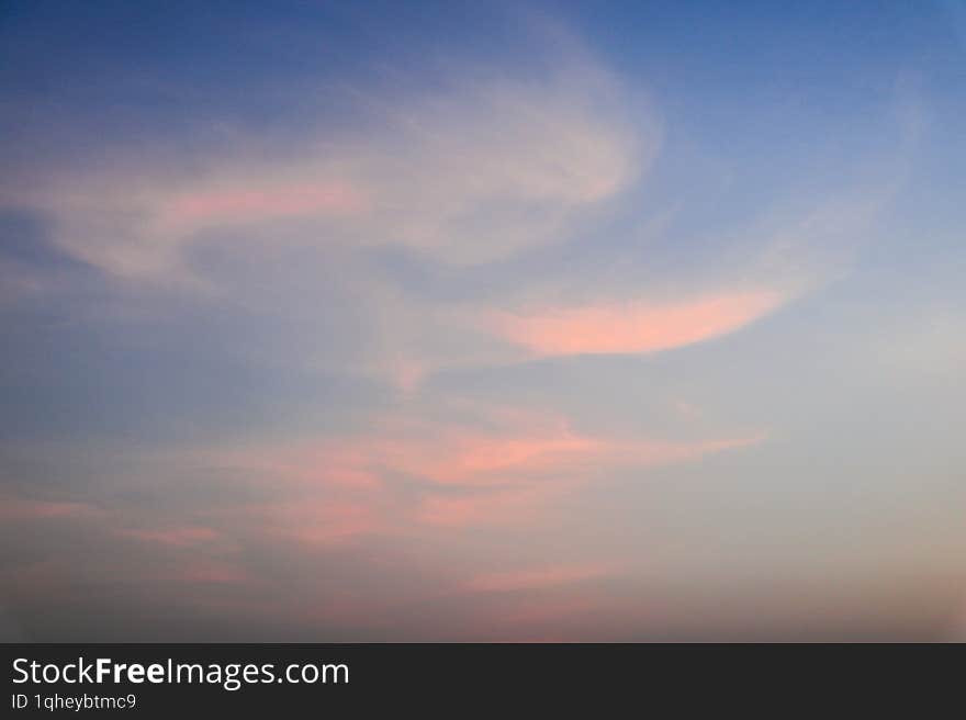 Beautiful calm serene dark blue sky during sunset with orange clouds on a summer evening