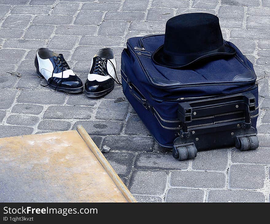 Clothing and props of a tap dancer include shoes, a wooden floor, and a bowler hat.