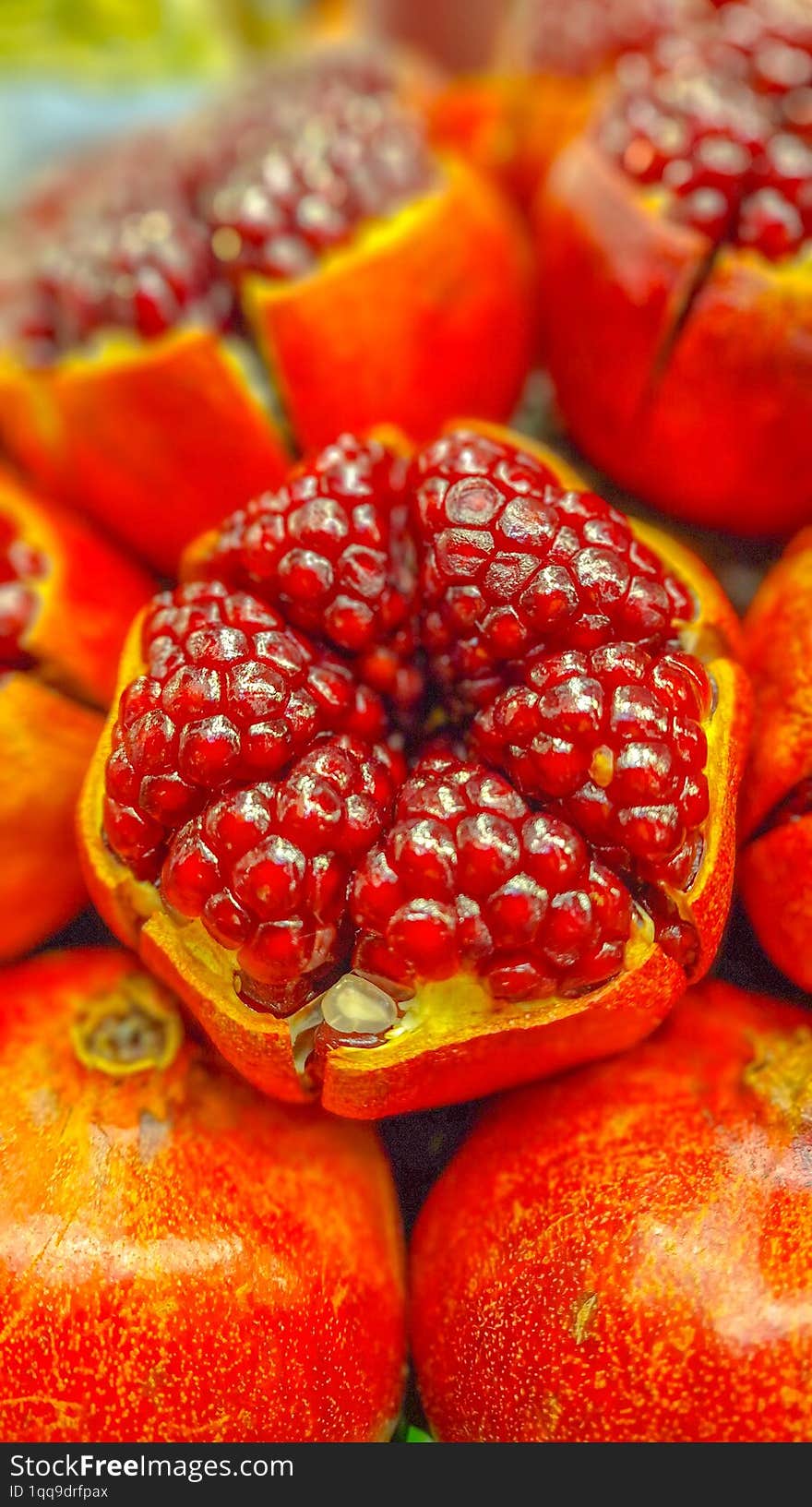 A close-up image of a pomegranate, showcasing its vibrant red seeds nestled within the fruit.