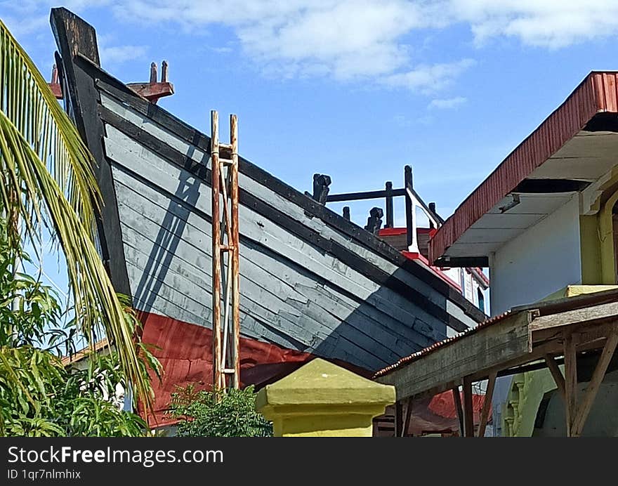 The wooden ship, 25 meters long, 5.5 meters wide and weighing 20 tons, was stuck on the roof of a house when a 9.3 magnitude earthquake and 30 meter high tsunami struck Aceh, Indonesia on December 26, 2004.