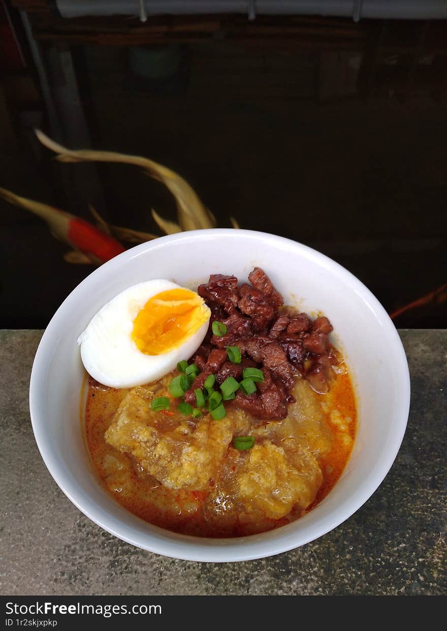 spicy boiled cow skin with egg and tempe on top, indonesia food