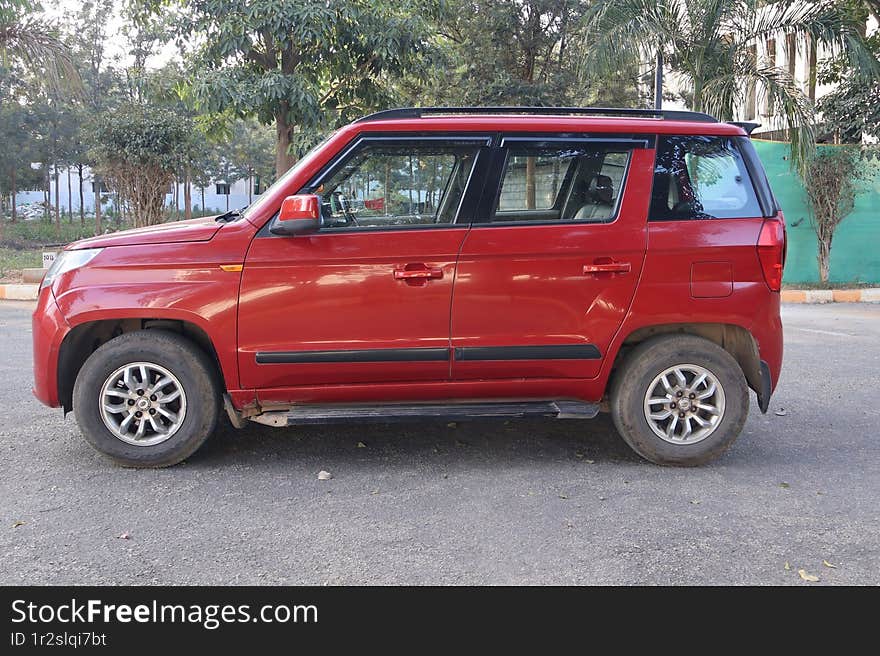 Mahindra TUV 300 Lava Red automatic SUV on the road. Mahindra TUV 300 Lava Red automatic SUV on the road.