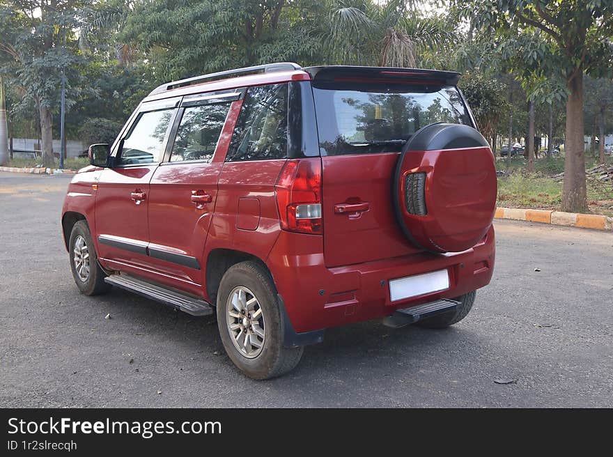 Mahindra TUV 300 Lava Red automatic SUV on the road. Mahindra TUV 300 Lava Red automatic SUV on the road.