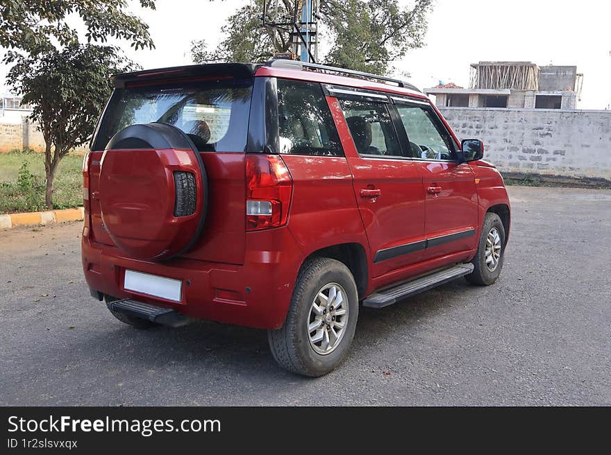 Mahindra TUV 300 Lava Red automatic SUV on the road. Mahindra TUV 300 Lava Red automatic SUV on the road.