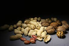 Unshelled Peanuts And Walnuts On A Dark Background Royalty Free Stock Image