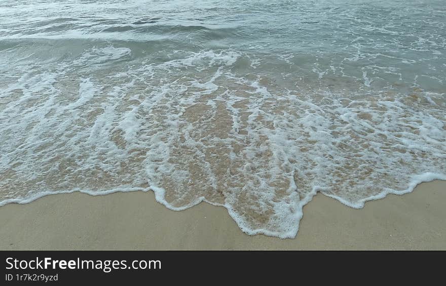 The Serene Beauty of the Ocean s Foamy Embrace