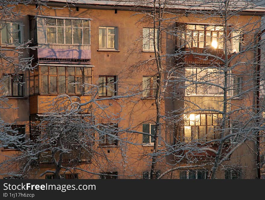 A multi-storey residential building on a frosty winter evening