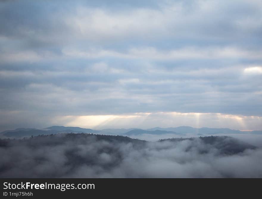 the morning light on the top of mountain contain among of cloud and mist.