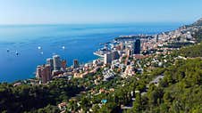 View Of Rich City Of Montecarlo, Tall Buildings, Narrow Streets Famous For Formula 1 Race. Mountain, Sea And Beautiful City On A S Stock Photos