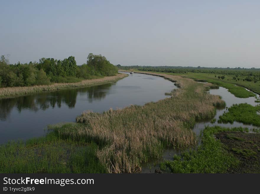 Beautiful water canals in the Vojvodina plain, cutting through the meadows.