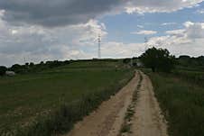 A Small, Dusty Rural Road Through The Fields. Royalty Free Stock Photos