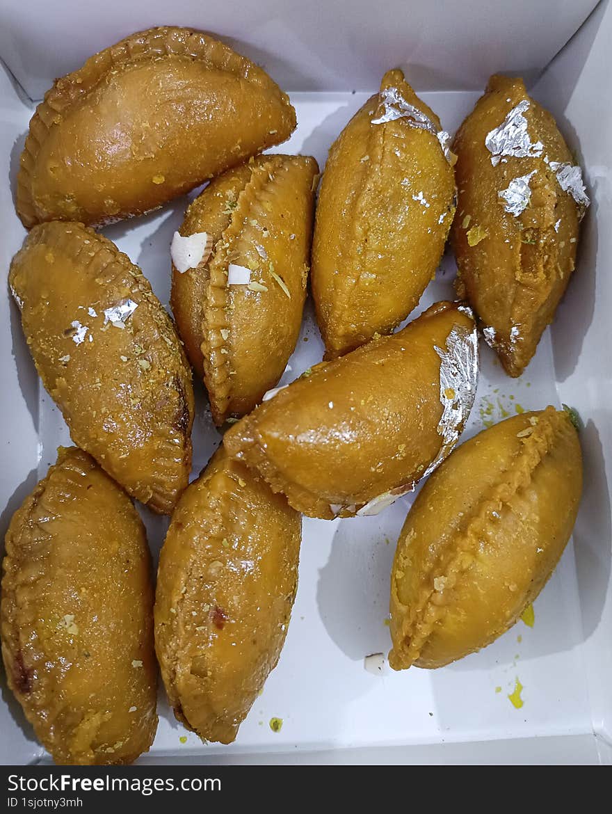 box of homemade gujiyas, a traditional Indian sweet made during holi festival