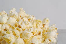 Golden And Crispy Popcorn In A Glass Bowl With Close-up View,  On White Background. Royalty Free Stock Image