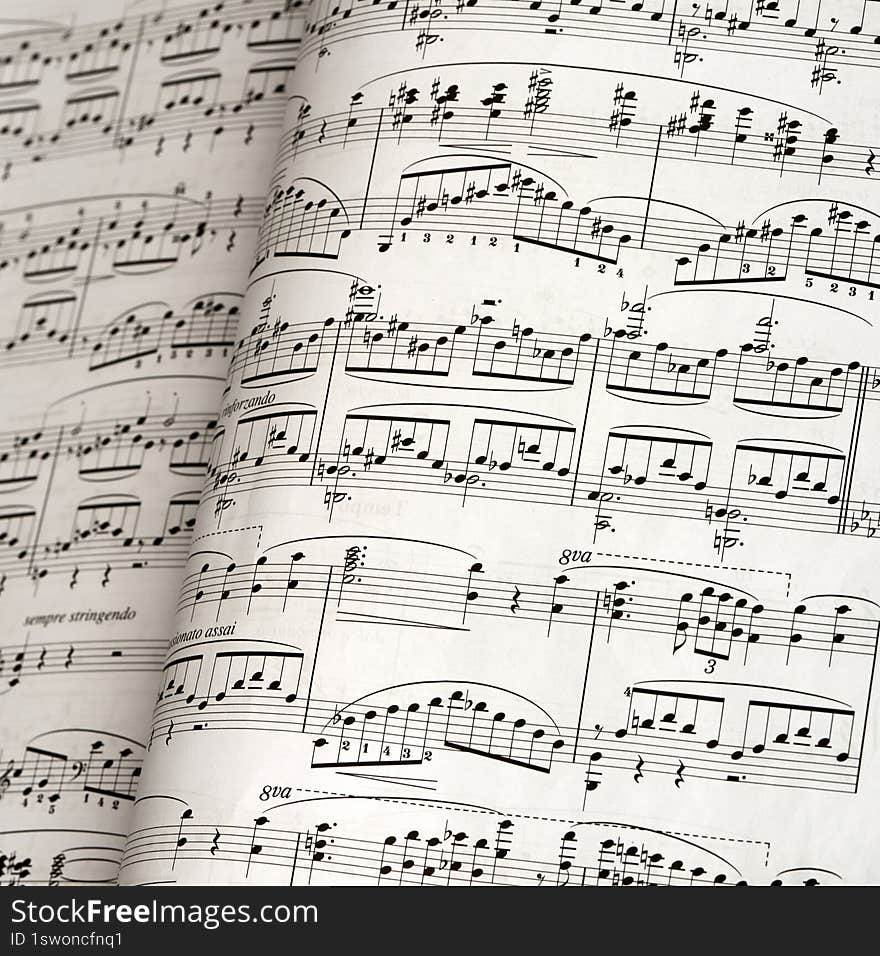 fragment of notes for playing piano as a background for artists