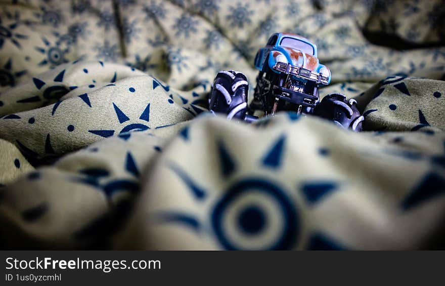 South Minahasa, Indonesia - January 29, 2023: toy monster car on blanket