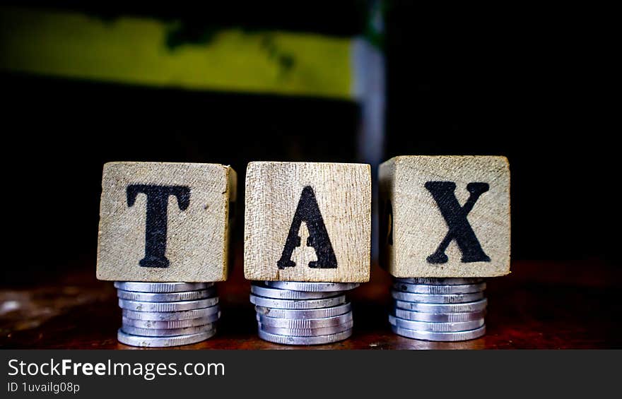 coins and blocks with tax inscription as background