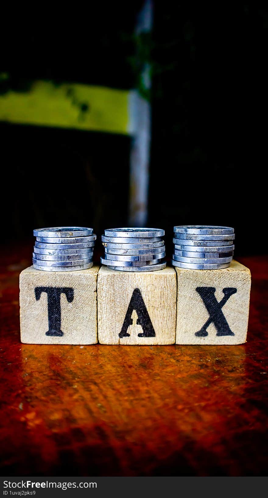 coins and blocks with tax inscription as background