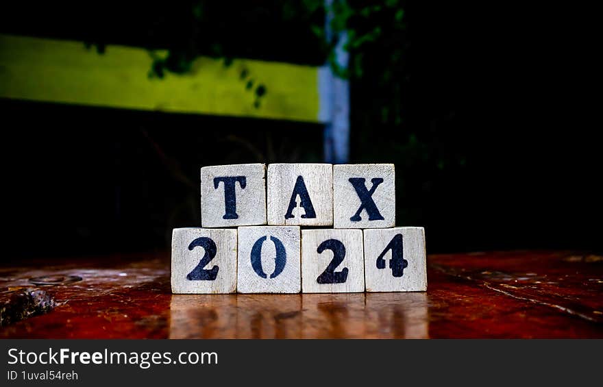 tax writing on wooden blocks as background