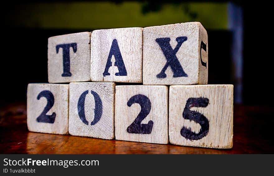 Tax Writing On Wooden Blocks As Background