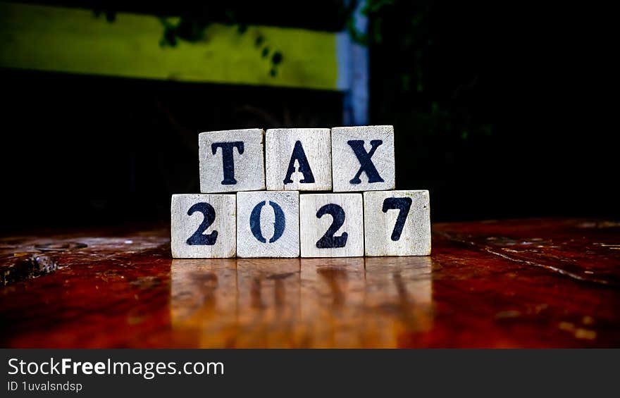 tax writing on wooden blocks as background