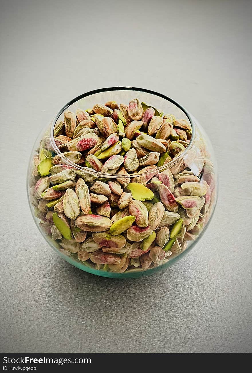 A close-uHandcrafted vibrant green pistachio slivers, showcasing natural richness, fresh aroma, and artisanal quality � perfect for gourmet desserts and authentic traditional dishes.p of fresh pistachios, capturing their natural texture and rich earthy tones � a symbol of tradition, health, and flavor.