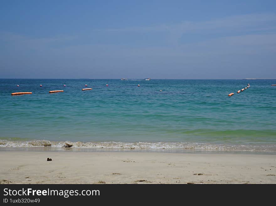 Transport in the United Arab Emirates. Khor Fakkan, Sharjah, UAE - April 22, 2023: Views of the Gulf of Oman and watercraft can be seen from Khor Fakkan Beach, Sharjah, UAE.